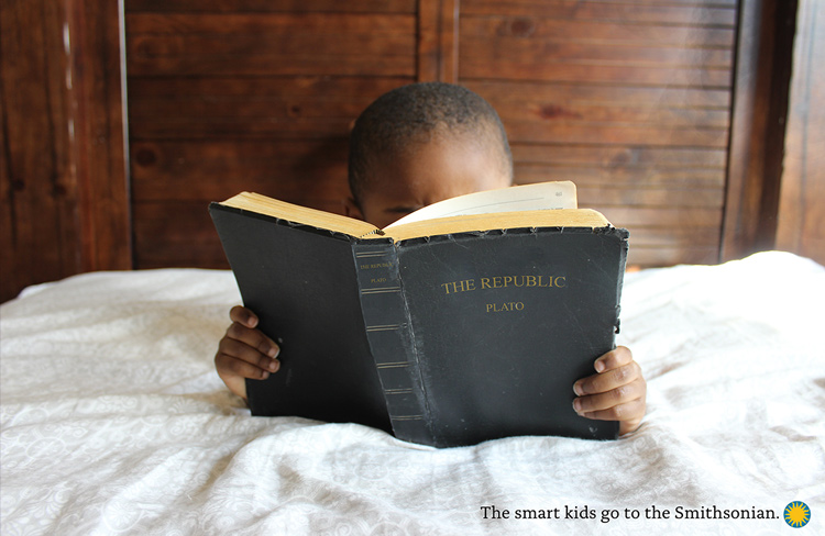 A Black child reads Plato's Republic with the caption "smart kids go to the Smithsonian"