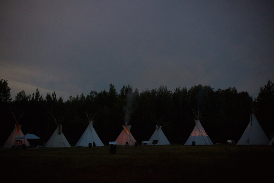 A line of teepees at dusk
