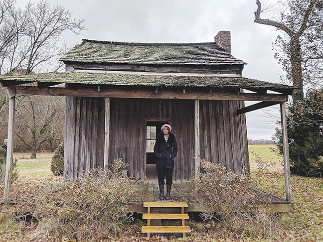 Cheryl Will in front of the last slave shack on the Tennessee plantation where her ancestors lived.