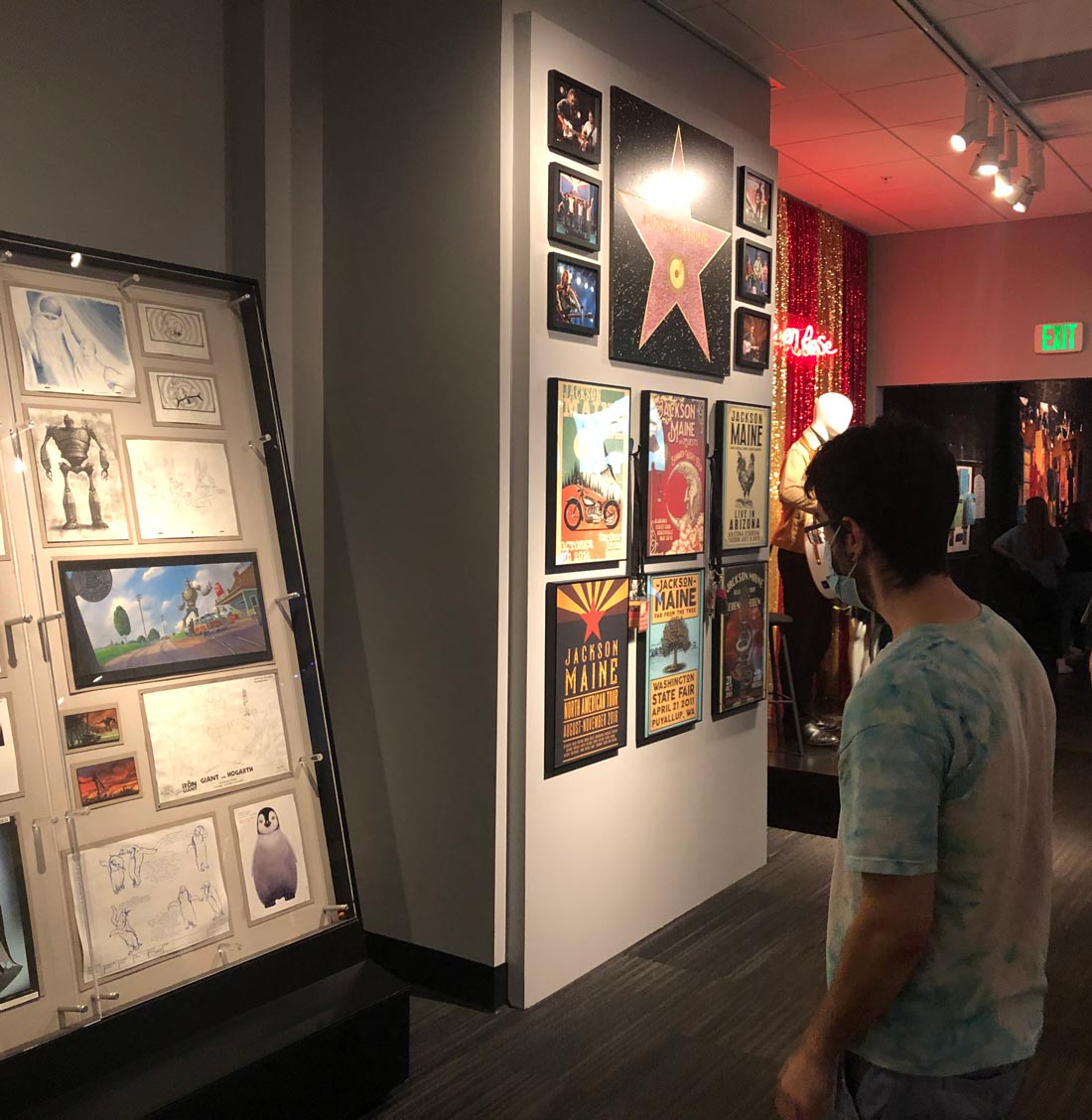 A student examines a wall of scripts and memorabilia from Warner Brothers Studios